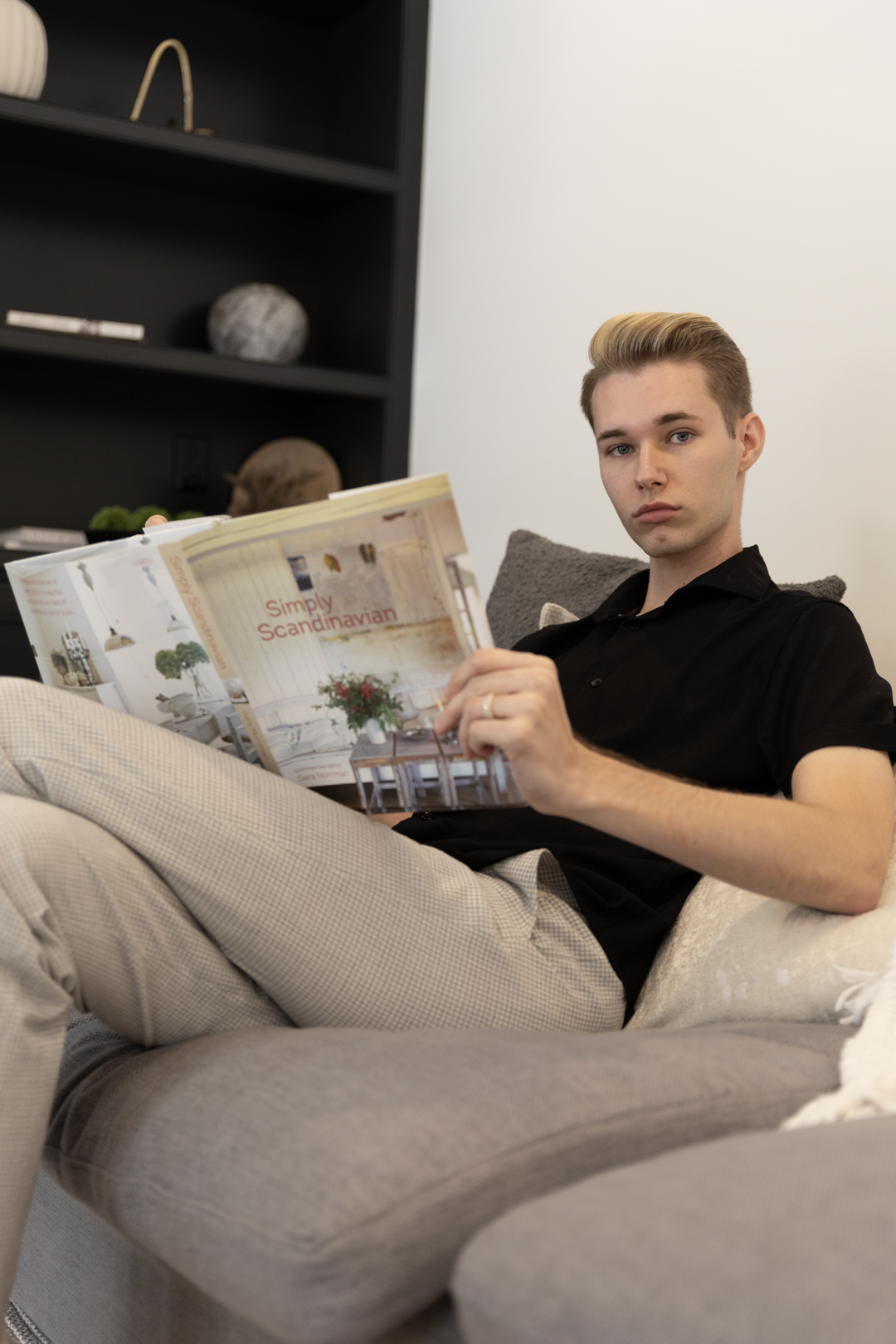 Dakota seated with an open design book